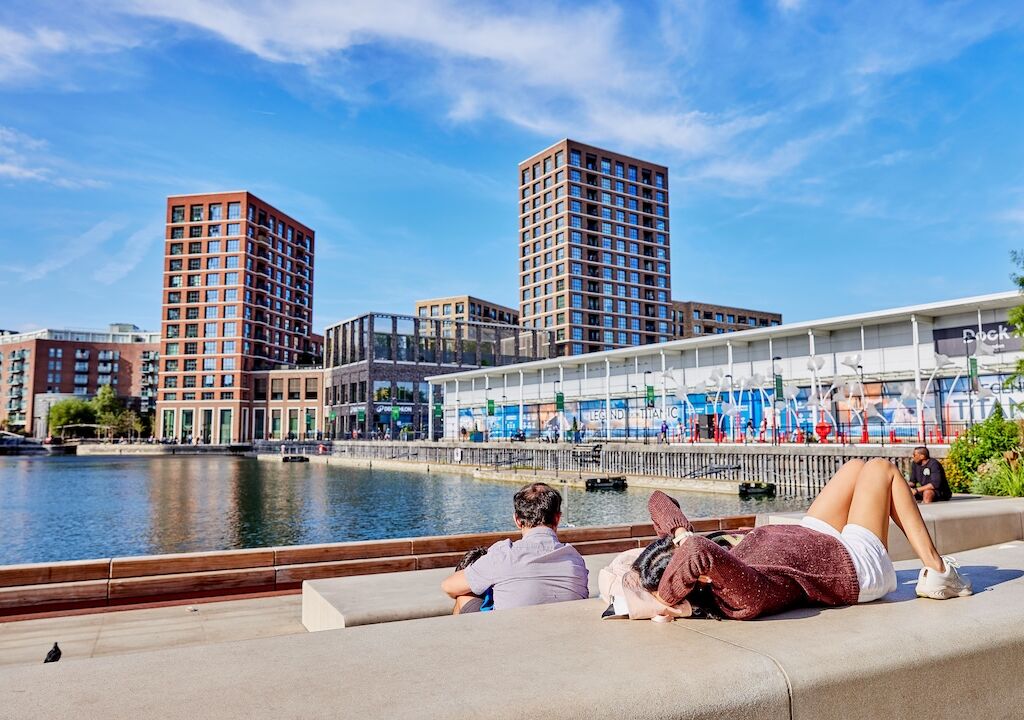 People relaxing on the dockside at Dockside Canada Water