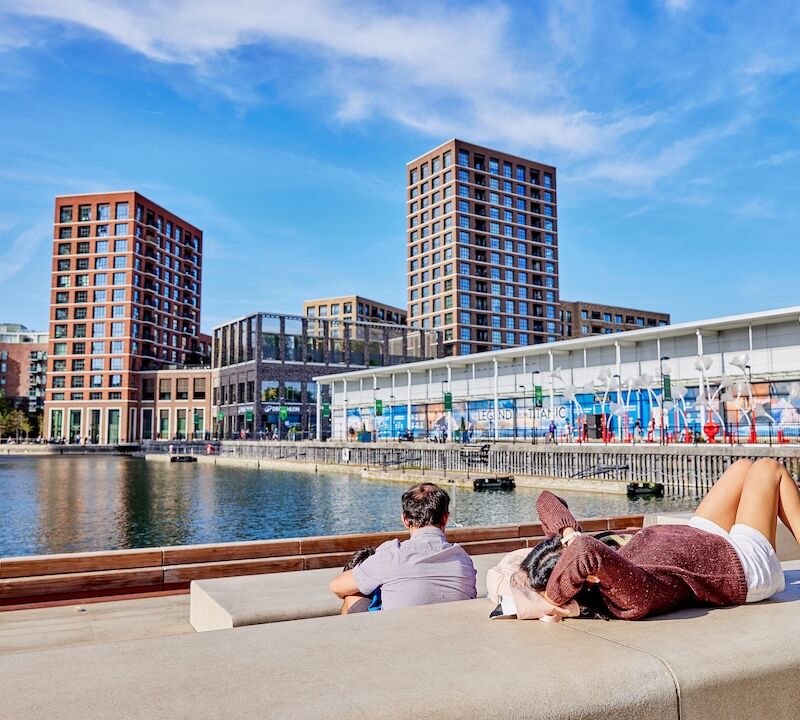 People relaxing on the dockside at Dockside Canada Water