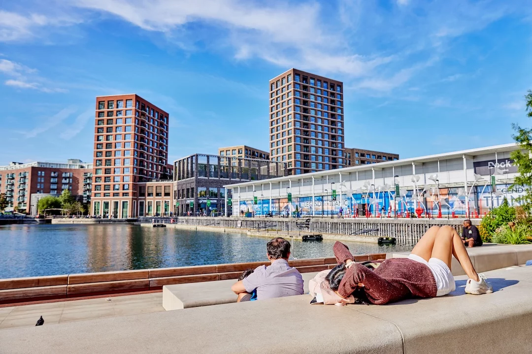 People relaxing on the dockside at Dockside Canada Water